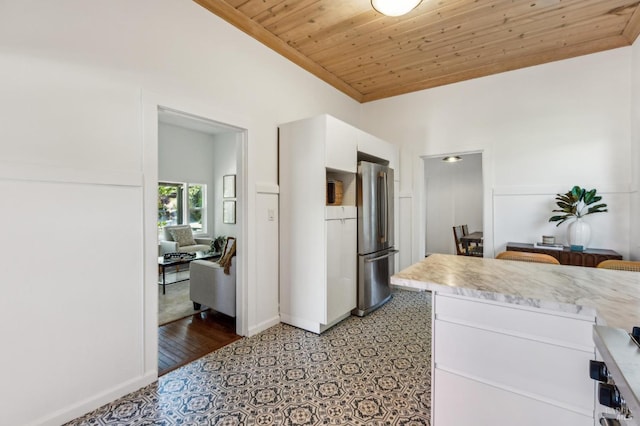 516 Howard St, Petaluma, CA 94952 - kitchen featuring freestanding refrigerator, wooden ceiling, light countertops, white cabinets, and baseboards