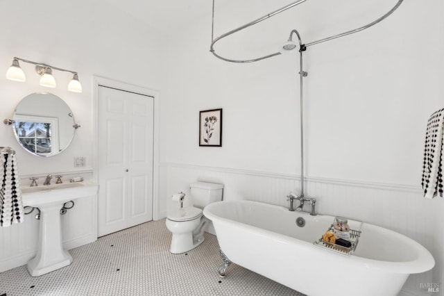 516 Howard St, Petaluma, CA 94952 - bathroom with a soaking tub, a wainscoted wall, and toilet
