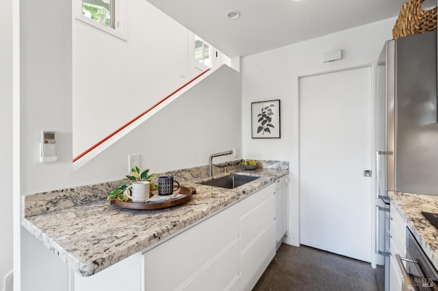 516 Howard St, Petaluma, CA 94952 - kitchen with a sink, white cabinetry, light stone countertops, recessed lighting, and dark colored carpet