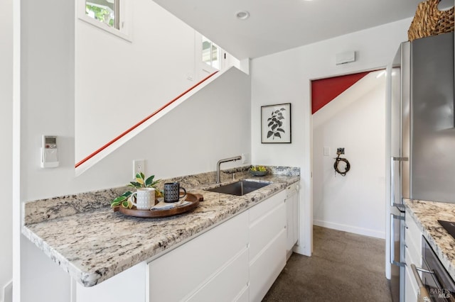 516 Howard St, Petaluma, CA 94952 - kitchen featuring white cabinets, a sink, baseboards, light stone counters, and recessed lighting