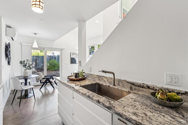 516 Howard St, Petaluma, CA 94952 - kitchen with a sink, a wall mounted AC, white cabinetry, finished concrete flooring, and plenty of natural light