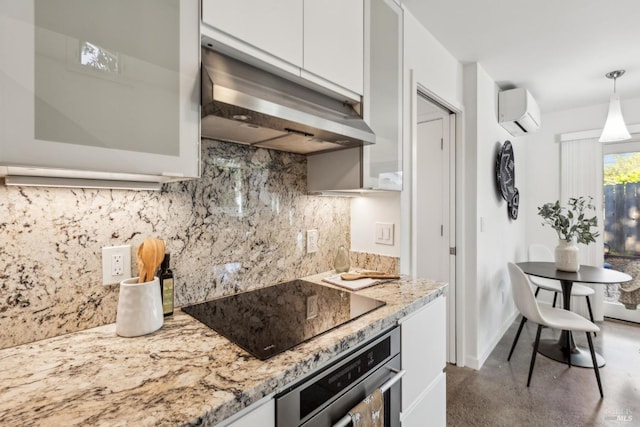 516 Howard St, Petaluma, CA 94952 - kitchen with stainless steel oven, under cabinet range hood, a wall mounted air conditioner, white cabinets, and black electric cooktop