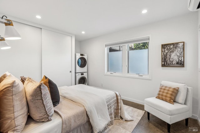 516 Howard St, Petaluma, CA 94952 - bedroom with stacked washer and clothes dryer, a wall unit AC, baseboards, recessed lighting, and a closet