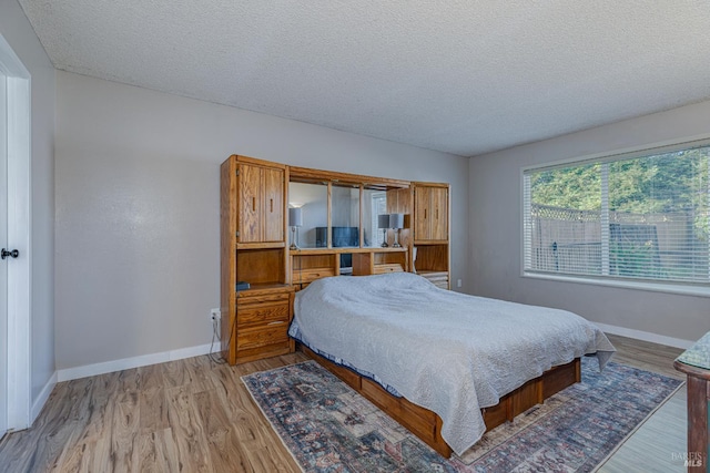 1133 Cielo Cir, Rohnert Park, CA 94928 - bedroom featuring a textured ceiling, baseboards, and wood finished floors
