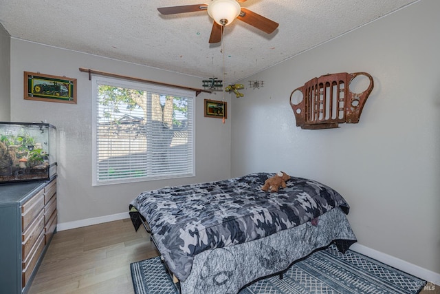 1133 Cielo Cir, Rohnert Park, CA 94928 - bedroom featuring wood finished floors, a textured ceiling, baseboards, and a ceiling fan