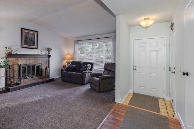 1133 Cielo Cir, Rohnert Park, CA 94928 - foyer entrance with a textured ceiling, a glass covered fireplace, lofted ceiling, baseboards, and wood finished floors