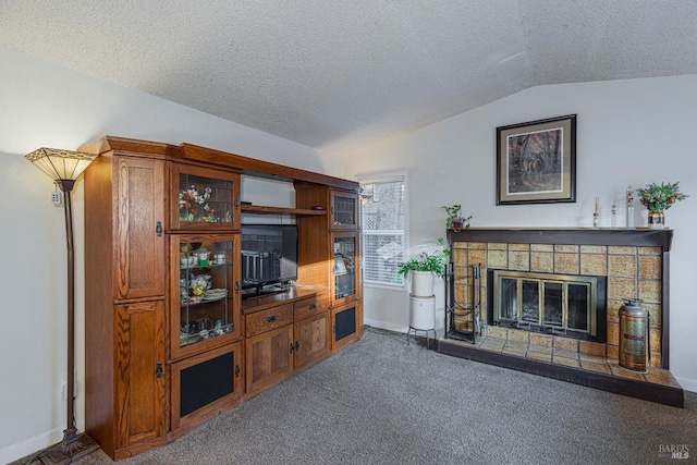 1133 Cielo Cir, Rohnert Park, CA 94928 - living area featuring vaulted ceiling, a glass covered fireplace, a textured ceiling, baseboards, and carpet