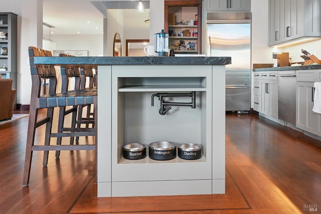 541 Oak Ave, San Anselmo, CA 94960 - kitchen with built in refrigerator, dark wood-style flooring, open shelves, and a kitchen breakfast bar