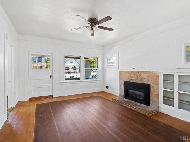 442 Piper St, Healdsburg, CA 95448 - unfurnished living room featuring a ceiling fan, a stone fireplace, wood finished floors, and baseboards