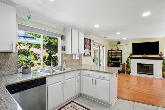 138 Nicole Way, Vallejo, CA 94589 - kitchen featuring a sink, stainless steel dishwasher, light tile patterned flooring, open floor plan, and a glass covered fireplace