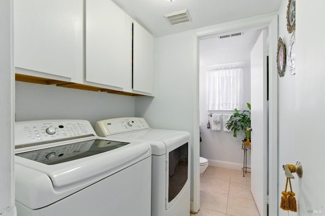 138 Nicole Way, Vallejo, CA 94589 - washroom with washer and clothes dryer, cabinet space, light tile patterned flooring, and baseboards