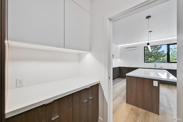 4966 Lakepointe Cir, Santa Rosa, CA 95403 - kitchen with modern cabinets, light countertops, light wood finished floors, hanging light fixtures, and a center island