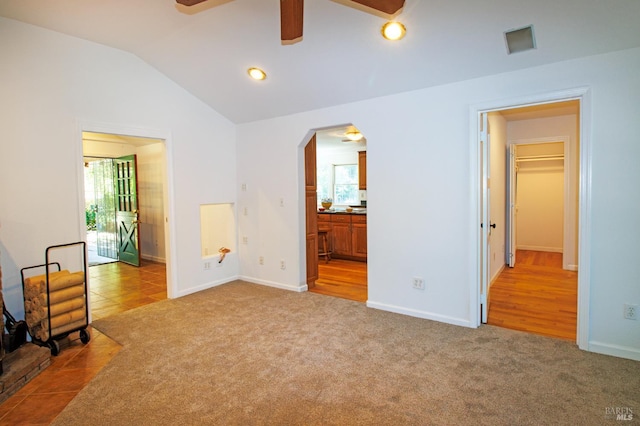 15866 Wright Dr, Guerneville, CA 95446 - unfurnished living room with carpet, ceiling fan, plenty of natural light, vaulted ceiling, and recessed lighting