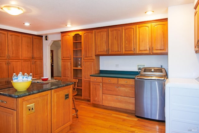 15866 Wright Dr, Guerneville, CA 95446 - kitchen with arched walkways, light wood-style floors, recessed lighting, brown cabinetry, and separate washer and dryer