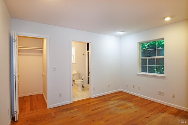 15866 Wright Dr, Guerneville, CA 95446 - unfurnished bedroom with a walk in closet, wood finished floors, and baseboards