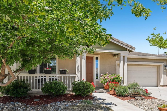 2032 Hunt St, Woodland, CA 95776 - view of front facade featuring stucco siding, driveway, a garage, and covered porch