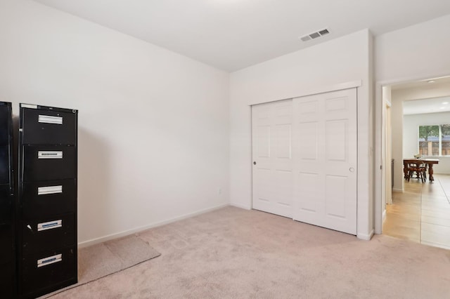 2032 Hunt St, Woodland, CA 95776 - unfurnished bedroom with light carpet, a closet, and baseboards