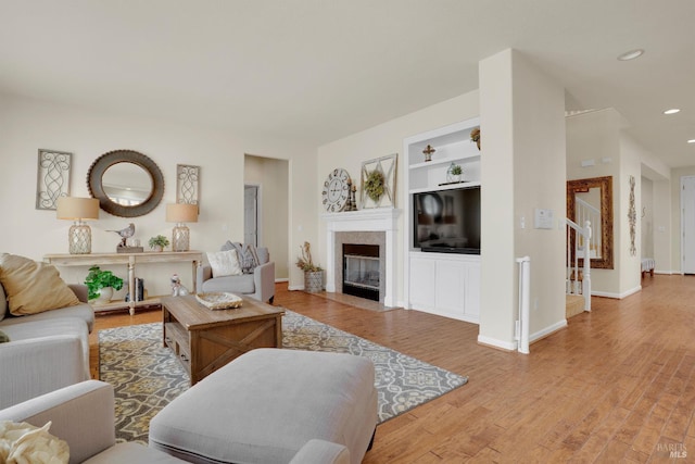 116 Birmingham Ct, Discovery Bay, CA 94505 - living area featuring built in features, light wood-style floors, recessed lighting, a fireplace, and baseboards