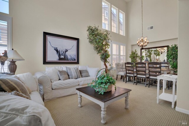 116 Birmingham Ct, Discovery Bay, CA 94505 - living room featuring a chandelier, carpet floors, a towering ceiling, and healthy amount of natural light