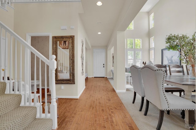 116 Birmingham Ct, Discovery Bay, CA 94505 - dining room featuring stairs, light wood-type flooring, baseboards, recessed lighting, and a towering ceiling