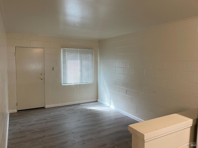 560 Talmage Rd, Ukiah, CA 95482 - empty room featuring dark wood-style flooring, concrete block wall, and baseboards