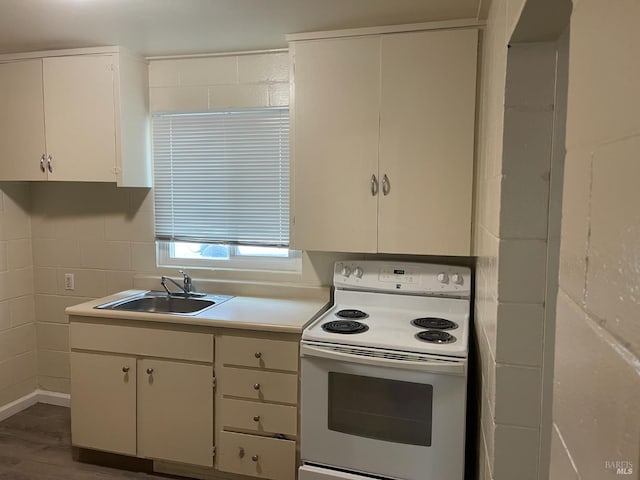 560 Talmage Rd, Ukiah, CA 95482 - kitchen featuring white electric stove, a sink, light countertops, wood finished floors, and white cabinets