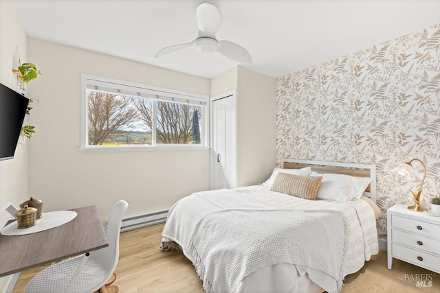 725 Lytton Station Rd, Healdsburg, CA 95448 - bedroom with a baseboard heating unit, wallpapered walls, a closet, a ceiling fan, and light wood-type flooring