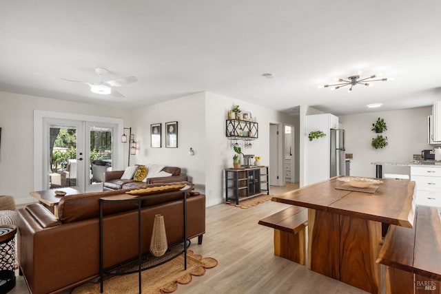 725 Lytton Station Rd, Healdsburg, CA 95448 - living area with light wood finished floors, french doors, ceiling fan, baseboards, and a chandelier