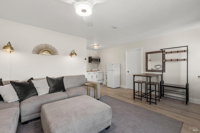 725 Lytton Station Rd, Healdsburg, CA 95448 - living room with ceiling fan, light wood-style floors, and baseboards