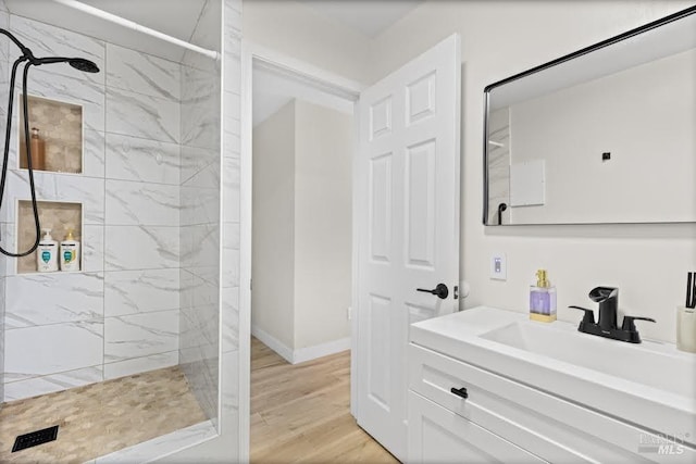 725 Lytton Station Rd, Healdsburg, CA 95448 - bathroom with a tile shower, wood finished floors, vanity, and baseboards