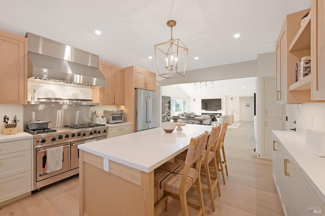 20 Almenar Dr, Greenbrae, CA 94904 - kitchen featuring high end appliances, wall chimney exhaust hood, a chandelier, open floor plan, and light countertops