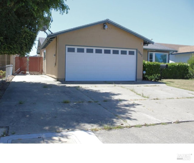 1863 Mini Dr, Vallejo, CA 94589 - ranch-style house featuring stucco siding, driveway, and a garage