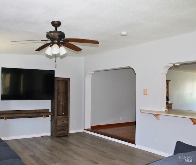 1863 Mini Dr, Vallejo, CA 94589 - unfurnished living room with wood finished floors, a ceiling fan, arched walkways, and baseboards