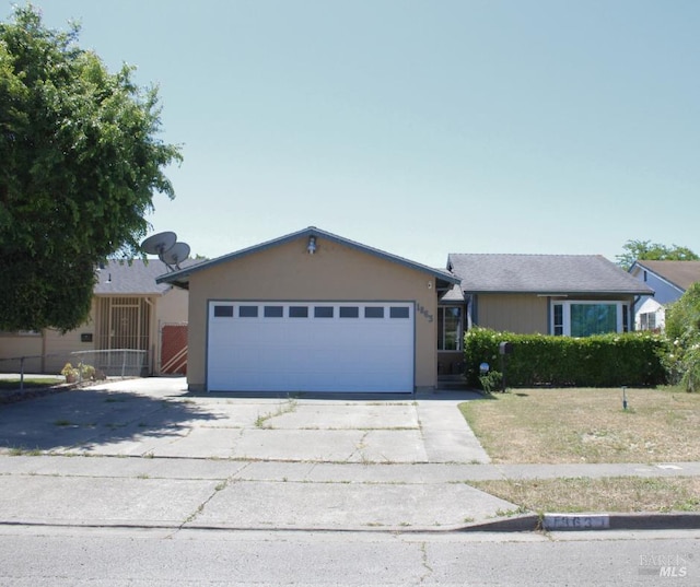 1863 Mini Dr, Vallejo, CA 94589 - ranch-style house with driveway, an attached garage, and stucco siding