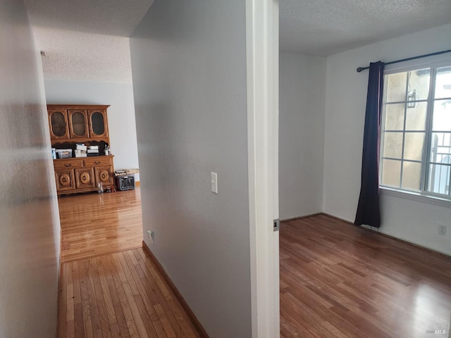 1863 Mini Dr, Vallejo, CA 94589 - hall featuring a textured ceiling, wood finished floors, and baseboards