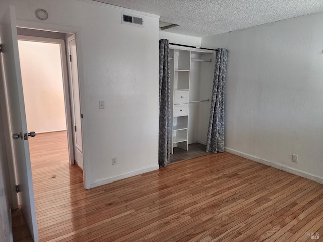 1863 Mini Dr, Vallejo, CA 94589 - unfurnished bedroom featuring wood finished floors, a textured ceiling, baseboards, and a closet