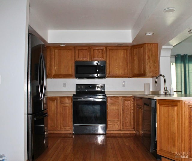 1863 Mini Dr, Vallejo, CA 94589 - kitchen featuring black appliances, brown cabinetry, dark wood-style flooring, a sink, and recessed lighting