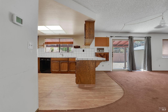 4009 Rimrock Dr, Antioch, CA 94509 - kitchen featuring tile countertops, black dishwasher, brown cabinetry, backsplash, and a textured ceiling