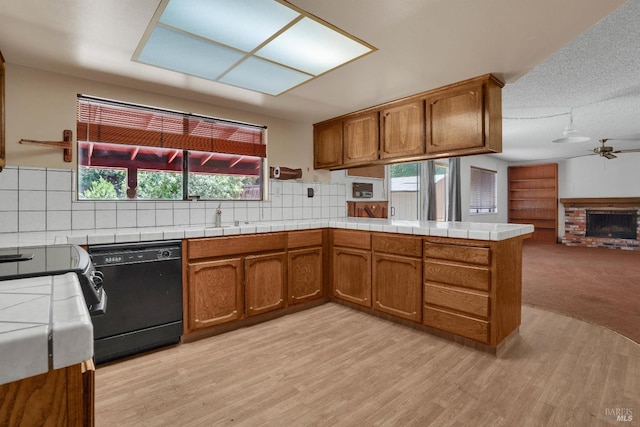 4009 Rimrock Dr, Antioch, CA 94509 - kitchen with dishwasher, brown cabinetry, tile countertops, and a peninsula