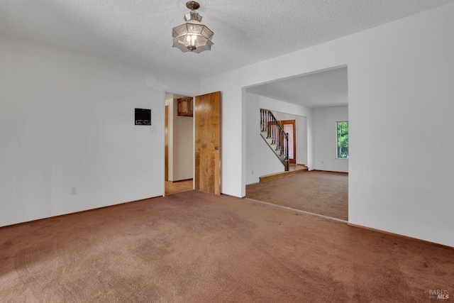 4009 Rimrock Dr, Antioch, CA 94509 - carpeted empty room featuring stairway and a textured ceiling
