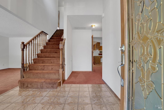 4009 Rimrock Dr, Antioch, CA 94509 - entryway featuring carpet flooring, a textured ceiling, and stairway