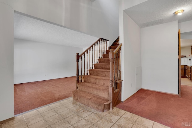 4009 Rimrock Dr, Antioch, CA 94509 - stairs featuring carpet floors, a textured ceiling, and tile patterned flooring