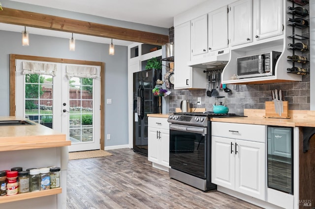46 N 4th St, Rio Vista, CA 94571 - kitchen featuring stainless steel gas stove, under cabinet range hood, beverage cooler, black fridge with ice dispenser, and decorative backsplash