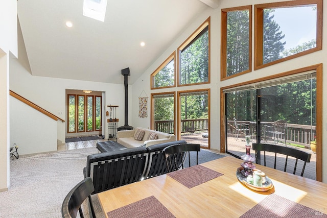 22111 Umland Cir, Jenner, CA 95450 - dining space featuring high vaulted ceiling, a wood stove, recessed lighting, wood finished floors, and a skylight