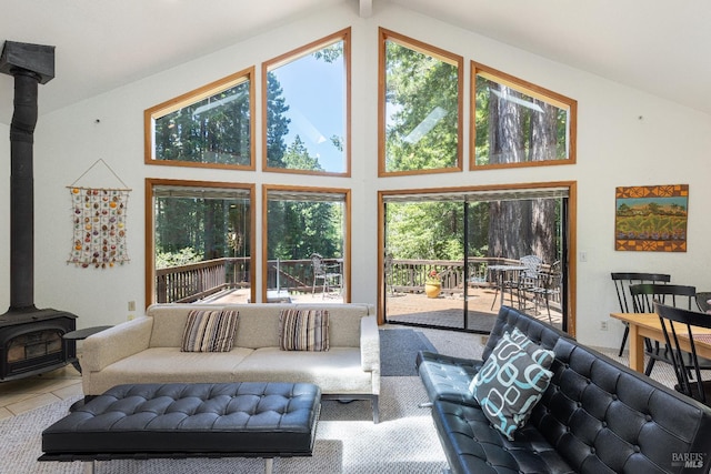 22111 Umland Cir, Jenner, CA 95450 - tiled living area featuring a wood stove, healthy amount of natural light, and high vaulted ceiling