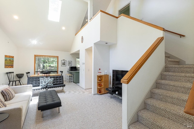 22111 Umland Cir, Jenner, CA 95450 - living room featuring stairway, light carpet, high vaulted ceiling, and recessed lighting