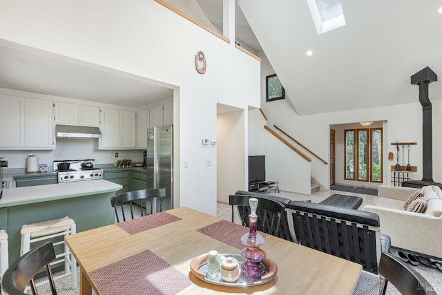 22111 Umland Cir, Jenner, CA 95450 - dining space with stairs, high vaulted ceiling, a skylight, and recessed lighting