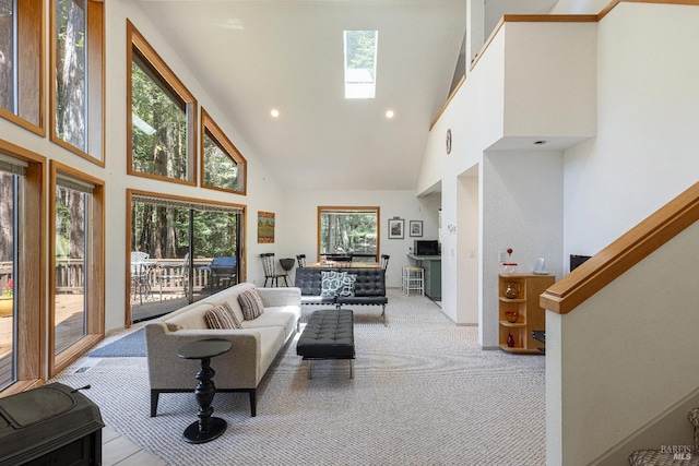 22111 Umland Cir, Jenner, CA 95450 - living area featuring high vaulted ceiling, light colored carpet, a skylight, and recessed lighting