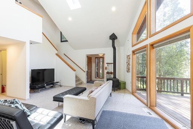 22111 Umland Cir, Jenner, CA 95450 - living area with stairs, a wood stove, light carpet, high vaulted ceiling, and recessed lighting