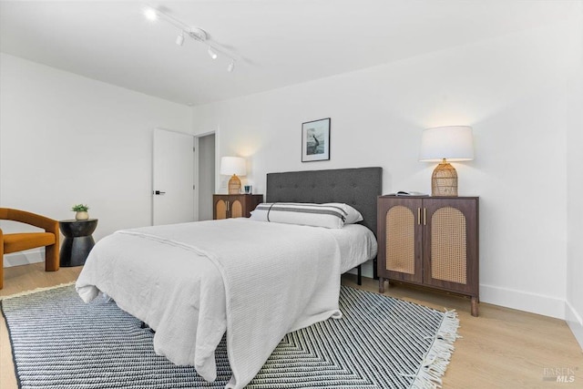 462 Hickory Ln, San Rafael, CA 94903 - bedroom featuring rail lighting, wood finished floors, and baseboards